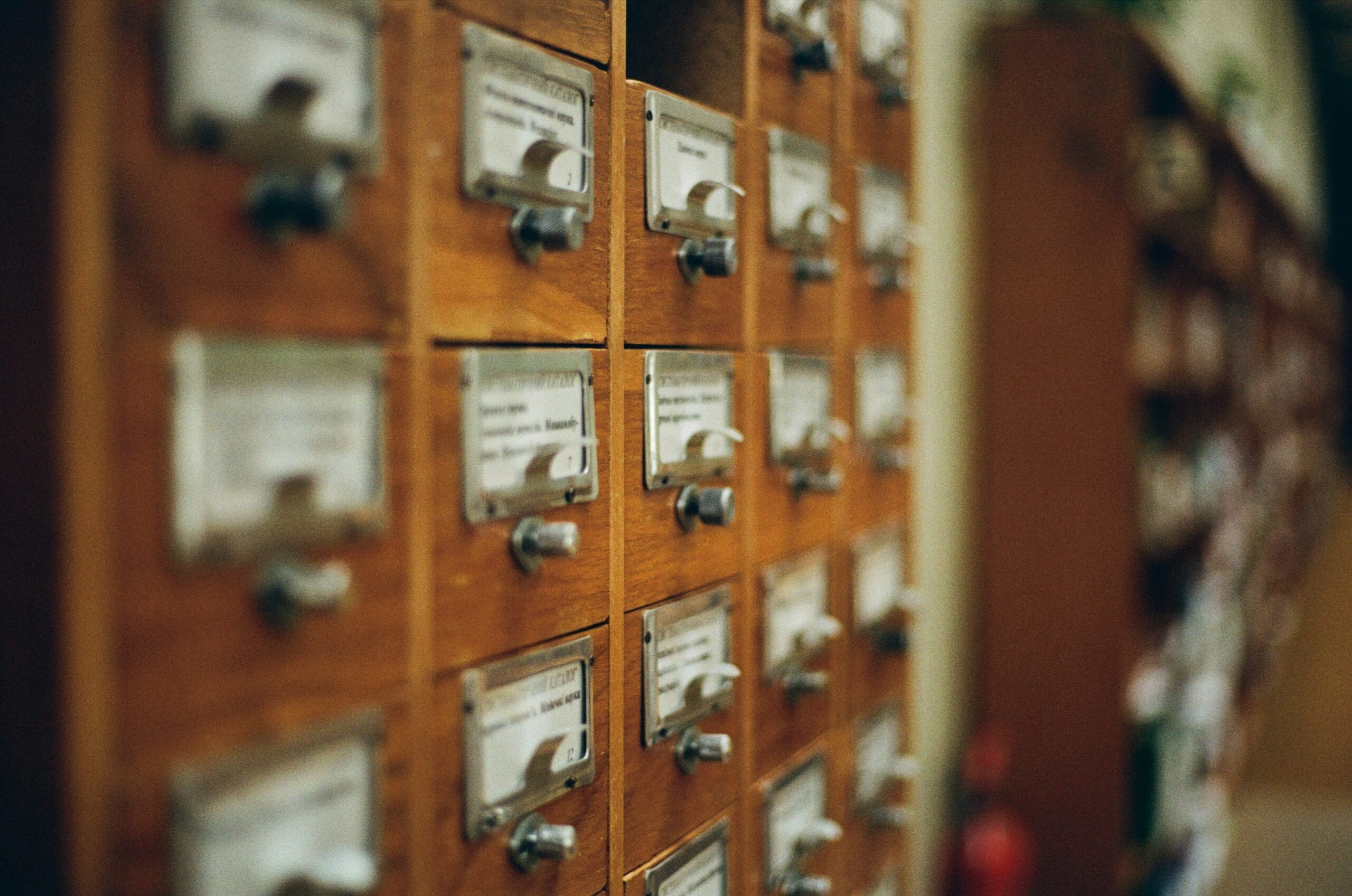 A wall of uniform gray mailboxes with one bright yellow mailbox standing out in the center, symbolizing a repository.